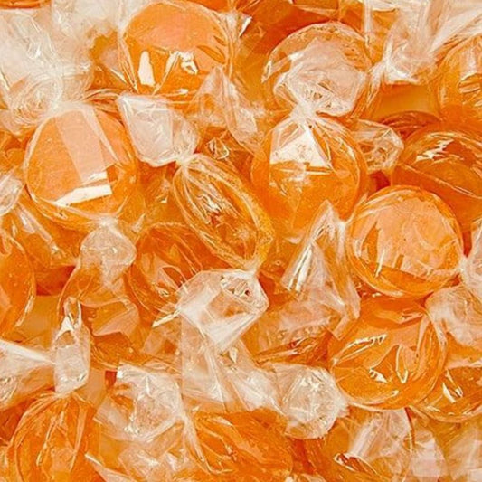 Orange hard boiled lollies wrapped in clear cellophane.