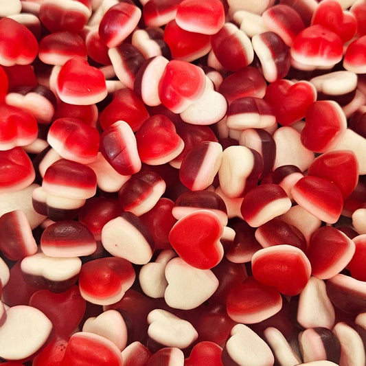Close-up of red, white, and brown heart-shaped candies, soft gummies