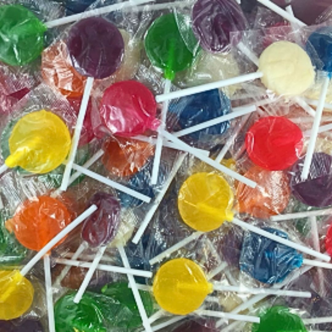 Assorted colorful lollipops on sticks with clear wrappers.