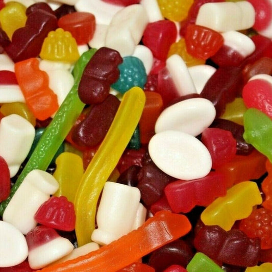 Assorted colorful gummy candies including worms, bears, and other shapes.
