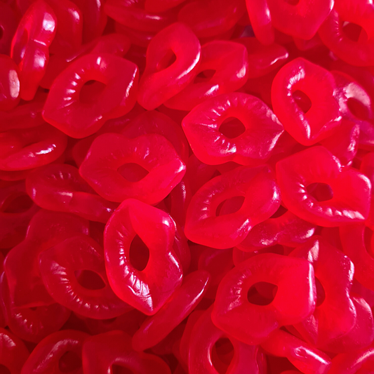 A close-up image of red gummy lips candy, with a heart-shaped cut-out in the center.