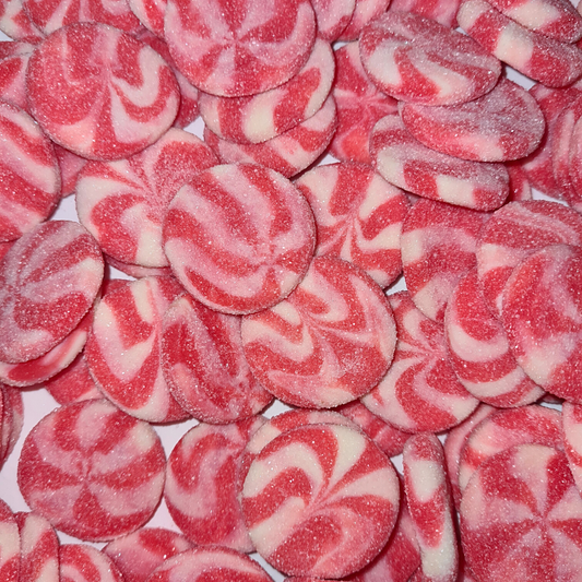A close-up image of red and white swirled candies, resembling lollipops, with a sugar coating.